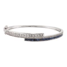 This is part of Chairish’s Fine Jewelry assortment.  This Brilliant Diamond and Blue Sapphire Cuff Bracelet in 18K gold showcases endlessly sparkling natural blue sapphire of 1.47 carats and 2 carats diamonds. Sapphire stimulates concentration and reduces stress.  Designed with perfect baguette cut blue sapphire and square cut diamonds studded in it to make you stand out on any occasion or event. The elegant style complements the attire beautifully and is a perfect Engagement Gift, Bridal Shower Luxury Sapphire Bracelet With Diamond Accents, Luxury Sapphire Bracelets With Diamond Accents, Luxury Sapphire Diamond Bracelet With Accents, Brilliant Cut Sapphire Diamond Bracelet In Fine Jewelry Style, Sapphire Diamond Bracelet With Brilliant Cut, Elegant Sapphire Diamond Bracelet With Brilliant Cut, Elegant Sapphire Bracelets With Brilliant Cut, Elegant Sapphire Bracelet With Brilliant Cut, White Gold Sapphire Diamond Bracelet