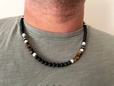 "Black Stone necklace with Tiger's Eye ,Black Gemstone necklace. Water-resistant Beautiful necklace, made of 100% of gemstones. The size of the stones in the necklace is 6 mm. The necklace comes in different sizes -- please choose yours at checkout. Perfect to keep or to give as a gift. This Necklace comes gift-wrapped, ready to be gifted. Materials: *Black stone *Howlite *Tiger's Eye *Pyrite *Agate All metals used are lead and nickel-free! Length: *15.5\"/40 cm *20\"/50 cm *24\"/60 cm Choose yo Casual Black Beaded Necklace As Gift, Casual Black Beaded Necklace For Gift, Casual Black Necklace For Gift, Beaded Necklace For Men, Black Gemstone Necklace, Mens Accessories Necklace, Black Stone Necklace, Beaded Necklace Black, Mens Bracelet Designs