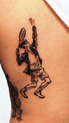 a man with a tennis racquet tattoo on his back is holding the racket