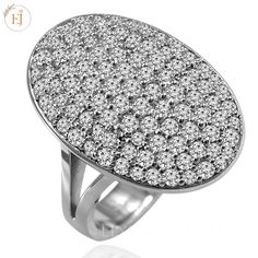 an oval shaped ring with white diamonds on it's sides, set in 18k white gold