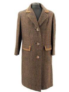 A fabulous true vintage wool overcoat weaved in brown and black textured stripes.  The oversized edged lapels and pocket flaps are stand-out features, as are the oversized wood effect buttons.  The coat is lined in a luxurious cognac-coloured satin lining. To the back, there is a half belt and vent for ease of movement in a long coat. A vintage must-have for any sartorial collector. Made by Pensor of London. Measurements: Chest: 40 inch / 101.5 cm Sleeve: 23 inch / 58 cm Length: 46 inch / 117 cm Brown Wool Coat With Button Closure, Brown Tweed Wool Long Coat, Brown Tweed Long Wool Coat, Brown Double-breasted Tweed Outerwear, Brown Formal Wool Coat With Buttons, Brown Double-breasted Tweed Jacket For Winter, Formal Brown Wool Coat With Buttons, Brown Wool Coat With Buttons For Formal Occasions, Brown Oversized Outerwear For Formal Events