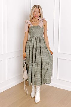 - Twirl into a perfect day with this charming midi dress! Its delightful floral print and smocked bodice bring a touch of sweetness, while the tied straps add a darling detail. Effortless style and carefree moments await! - Unlined material with appetite floral print featuring ivory, green, and pink hues - A square cut neckline with ruffle detailing - Tied straps - A smocked bodice - An elastic waistline - Ruffle detailing - A flowy yet flattering silhouette that ends in a straight midi length h Chic Smocked Dress With Tie Straps For Spring, Spring Sundress With Smocked Tie Straps, Spring Smocked Sundress With Tie Straps, Spring Brunch Smocked Dress With Tie Straps, Green Midi Smocked Dress For Brunch, Spring Smocked Midi Dress With Tie Straps, Green Smocked Midi Dress For Garden Party, Spring Green Midi Dress With Smocked Bodice, Green Midi Length Smocked Sundress