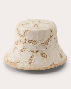 An embrace of bohemian luxury, the Lizette hat pairs its braided raffia base with embroidered cotton overlay that features crocheted flower motifs. The flat crown and downward slanted brim give nod to traditional bucket styles. Inner adjustable band Flat crown Angled brim UPF 50+ Braided raffia trim Embroidered crochet overlay Outer: 100% cotton Lining: 100% raffia Spot clean Materials sourced from Italy Made in Sri Lanka Measurements Brim: 3in Embroidered Crochet, Embroidered Bucket Hat, Helen Kaminski, Crochet Overlay, Large Hobo Bag, Flower Motifs, Flats Patterns, Shades Of Beige, Cream And Gold