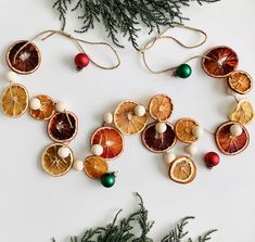 "<< Are you looking for a natural garland for your Christmas decor? Then this dried orange slice garland with beads is the perfect touch to your holiday decorating. They add a fragrant scent of citrus to your home. Give your mantle, fireplace or tree a little whimsy this year.  << This garland has a mixture of 3 oranges. Mandarin, Navel and Blood oranges.  A total of 16 oranges and 15 beads on a 6' jute string.  << Please note that blood oranges are seasonal and only available from November through March. A pink/red grapefruit will be substituted in its place during off season. << The loops are adjustable so you can shorten the string if need be. Please note that items can shift on the string, just space accordingly to your liking.  << Approximate Measurements: << 6' jute string with end l Orange Slice Garland, Natural Garland, Eco Friendly Christmas Decorations, Zero Waste Christmas, Mantle Fireplace, Festive Activities, Bow Garland, Sustainable Christmas, Eco Friendly Christmas