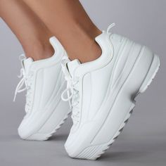 Unleash Your Inner Visionary With The Lily 5005 Dream Cypher White Platform Sneakers From Berness. This Rave Platform Sneakers Features White Colored Vegan Leather Upper, Stitch Detailing On The Sides, Lace Up Closure, Chunky Rubber Platform Sole. These Super Lightweight Rave Platform Sneakers Will Get You Going From Day To Night. Lily 5005 Dream Cypher White Platform Sneakers Vegan Leather Upper Super Lightweight Lace Up Closure Chunky Platform Outsole True To Size White Sports Platform Sneakers With White Laces, Synthetic Platform Sneakers With Laces, White Wedge Sneakers With Textured Sole And Round Toe, Spring Platform Sneakers With White Laces, White Wedge Sneakers With Textured Sole, White Leather Lace-up Wedge Sneakers, White Lace-up Leather Wedge Sneakers, White Synthetic Platform Sneakers, White Flat Heel Platform Sneakers