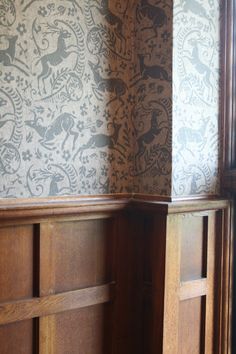 two wooden doors with decorative wallpaper on them