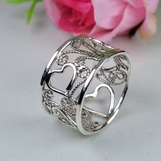 Filigree ring made in the filigree technique by intricate metal work, creating a rich floral and delicat look. The wide band ring is inspired by Boho jewelry combined with modern design. This sterling silver heart ring is perfect for a beloved woman, and as a pampering gift for yourself. The structure of the ring is approximately 12 mm wide. The ring is very flattering to the finger, comfortable to wear as a jewel for everyday use and impressive as a jewel for a special occasion. The ring is made of 925 sterling silver by hand tools only. Each piece of jewelry is handmade to order, therefor due to the special nature of handcrafting, there may be slight differences compared to the jewelry in the photos shown. This adds to the charm and individuality of each piece, making it truly one-of-a-k Bohemian Rings With Intricate Design For Anniversary, Handmade Silver Heart Ring For Anniversary, Silver Engraved Open Heart Ring, Silver Open Heart Ring Engraved, Silver Round Flower Ring For Valentine's Day, Silver Flower Ring For Valentine's Day, Bohemian Rings With Intricate Design For Promise, Sterling Silver Engraved Open Ring With Intricate Design, Bohemian Flower Ring With Intricate Design For Gift