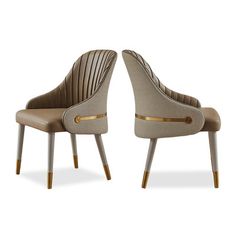 two beige chairs with gold trims on the legs and one is facing each other