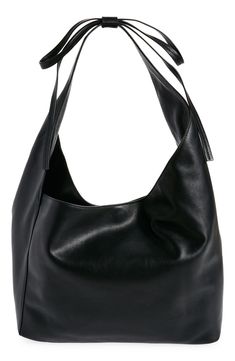 This medium-sized, slouchy leather tote with an asymmetric topline takes a subtle approach to the season's bow trend with a decorative tie detail on the strap. Magnetic closure Shoulder strap Interior zip pocket; card slot Fits most 13" laptops Leather lining Leather Imported Black Slouchy Bag, Slouchy Leather Tote, Bow Trend, Slouchy Bag, Black Leather Bag, Black Leather Tote Bag, Pocket Card, Black Leather Tote, Black Accessories