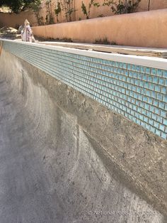 a skateboarder is riding his board down the ramp