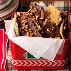 a red container filled with chocolate and nuts