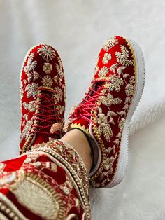 "Step into a world of elegance with our exquisite handmade bridal sneakers, meticulously crafted to add a touch of glamour to your special day. Each pair is adorned with intricate Zari work, delicate beads, lustrous pearls, and intricately woven silk threads, creating a stunning fusion of traditional craftsmanship and contemporary style. Our bridal sneakers are more than just footwear; they are a celebration of your unique style and the embodiment of timeless beauty. The Zari detailing adds a re Party Wear Shoes Women, Wedding Shoes Bride Red, Sneakers Bride Wedding Dress, Indian Wedding Shoes Brides, Bride Footwear Indian, Indian Shoes Women, Bridal Footwear Indian, Bridal Shoes Indian, Indian Bridal Shoes