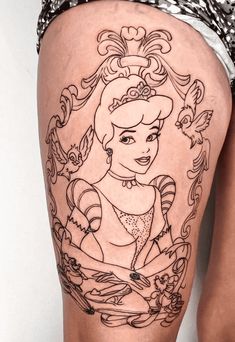 a woman's thigh with a tattoo of a princess and flowers on the side