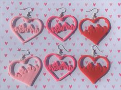 These 3D-printed flaming heart earrings are perfect for Valentine's Day! Grab a pair for yourself, your date, or your bestie. They are made of lightweight plastic, so they won't weigh down your ear.  The light pink and filled heart styles are limited Valentine's Day exclusives, so get them while you can! 3d Printed Earring, Valentine's Day Heart-shaped Novelty Earrings, Valentine’s Day Earrings, 3d Printed Valentines, 3d Earrings, Printed Earrings, 3d Printed Earrings, Flaming Heart, 3d Printing Business