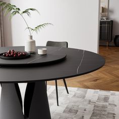 a black table with two white vases on it and some berries in the middle