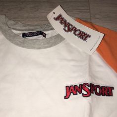 Brand New, With The Original Tag Still, Never Been Used. Color - White, Grey, Orange, Front Embroidered Logo - Red. Back Big Logo - Black. Material - 95% Cotton 5% Elastane Casual White T-shirt With Embroidered Logo, White Embroidered Logo T-shirt For Sports, White T-shirt With Embroidered Logo For Sports, White Sports T-shirt With Embroidered Logo, Sporty Spring Tops With Embroidered Logo, White Embroidered Logo Top For College, White Sports Top With Embroidered Logo, White Sports Tops With Embroidered Logo, White Tops With Embroidered Logo For Sports