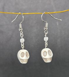 Fish hook dangle earrings with a white bead and skull. Skull Earrings, White Beads, Fish Hook, Festival Season, Jewelry Earrings Dangle, Dangle Drop Earrings, Dangle Earrings, Jewelry Earrings, Accessory Gift