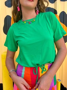 Wear your joy with the Joyful Green Drawstring top! You will love this top for its effortless style, drawstring bottom that gives you flexibility on how you style it, and of course the fun Kelly green color! This top is roomy for its size so we recommend sizing down if between sizes and if you want a more snug fit. Adjustable drawstring Fun Kelly Green color Breezy fit to beat the summer heat Slightly cropped so it is great with high-waisted bottoms True to size 92% Polyester 8% spandex Kate is Cotton Beach Tops With Drawstring, Short Sleeve Drawstring Top For Vacation, Trendy Green Top With Drawstring, Summer Cotton Tops With Drawstring, Short Sleeve Top With Drawstring For Vacation, Drawstring Short Sleeve Tops For Beach, Short Sleeve Drawstring Top For Beach, Spring Multicolor Tops With Drawstring, Summer Drawstring Tops For Day Out