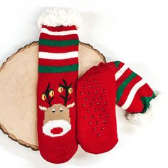 Red socks that has Rudolph's face with lights on the antlers towards the bottom of the socks. These socks also have green and white stripes on the ankle parts, has rubber grips on the bottom, and white fluff on the top of the socks. these socks are pictured laying on a piece of wood on a white background. Giddy Up Glamour, Perfect Stocking Stuffers, Cute Socks, Slipper Socks, Stocking Stuffer, Stocking Stuffers, Christmas Stockings, Reindeer, Sale Items