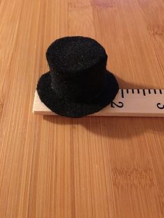 6.00 USD Mini black top hat. 2” brim diameter, 1” diameter opening . Fits on a lollipop. Price is for one hat. Navy Blue Top Hat Tree With Flower, Making Miniature Hats, Wine Bottle Topper, Black Top Hat, Bottle Toppers, Mini Top Hat, Small Christmas Trees, Mini Top, Doll Hat