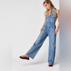 Get Ready To Turn Heads With These Stunning Citizens Of Humanity Mallory Wide Leg Overalls. Made From 100% Organic Cotton Denim, These Overalls Feature A Square Neckline, Button Closure, And Adjustable Straps For A Comfortable Fit. The Wide-Leg Design Is Perfect For Any Occasion, Whether You're Attending A Wedding, A Party, Or Just Running Errands. These Overalls Come In A Beautiful Blue Color And Are Accented With Buttons For A Touch Of Retro Style. They Also Include Pockets For Added Convenien High Rise Relaxed Fit Overalls In Medium Wash, High Rise Medium Wash Relaxed Fit Overalls, Denim Overalls With Relaxed Fit, High Waist Medium Wash Overalls For Workwear, Relaxed Fit High Waist Medium Wash Overalls, Blue Straight Leg Denim Jumpsuit, High Rise Relaxed Fit Dark Wash Overalls, High Rise Dark Wash Relaxed Fit Overalls, Blue Denim Wide Leg Overalls