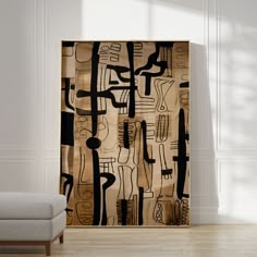 an abstract painting on the wall next to a couch in a room with white walls