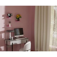 a desk with a computer on top of it in front of a window and sunflowers