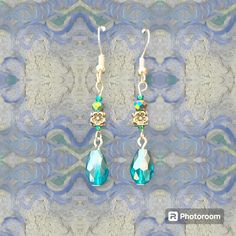 These elegant floral blue-tone cystal drop earrings are the perfect accessory to add a touch of elegance to any outfit. These earrings include a boho Silver intricate flower design bead that exude a timeless charm that is both classic and contemporary and a Blue colored Crystal drop bead. Blue Bohemian Teardrop Flower Earrings, Bohemian Blue Teardrop Flower Earrings, Blue Teardrop Bohemian Flower Earrings, Elegant Blue Faceted Beads Earrings, Bohemian Crystal Drop Earrings, Elegant Turquoise Drop Flower Earrings, Elegant Turquoise Flower Drop Earrings, Elegant Turquoise Drop Crystal Earrings, Elegant Blue Crystal Earrings With Faceted Beads