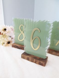 the table numbers are made out of wood and have gold numbers on each one side