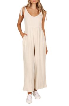 Elevate your contemporary wardrobe with this tie-shoulder linen jumpsuit finished with wide legs and handy side pockets. Pull-on style Adjustable tie straps Side-seam pockets Unlined 100% linen Hand wash, dry flat Imported Beige Linen Casual Jumpsuits And Rompers, Chic Cotton Jumpsuits And Rompers With Tie Straps, Linen Jumpsuit For The Beach, Chic Linen Jumpsuits And Rompers With Tie Waist, Beige Linen Jumpsuits And Rompers For Loungewear, Beige Linen Overall Jumpsuits And Rompers, Beige Linen Overalls Jumpsuit, Casual Solid Color Jumpsuits And Rompers With Tie Back, Casual Jumpsuits And Rompers With Tie Back