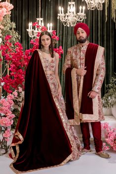 The epitome of opulence in our RAJAN Gold and Red Wedding Sherwani. Adorned with intricate embroidery and dazzling gold sequins, this rosy hued sherwani is a beautiful choice for any Indian groom. With embroidered floral motifs in shades of peach, smoke blue, and mint, this sherwani is the perfect complement to almost any color bridal lehenga. Custom lining color available upon request for a truly personalized touch. Details Thread and Sequin Embroidered Double-layer Tulle Dry Clean Only Item #1 Floor-length Sherwani With Sheer Dupatta For Reception, Anarkali Sherwani With Zari Work For Traditional Ceremonies, Reception Sherwani With Sheer Dupatta, Bollywood Style Sherwani With Sheer Dupatta, Festive Sherwani With Sheer Dupatta For Reception, Festive Floor-length Sherwani With Sheer Dupatta, Red Bandhgala For Wedding And Eid, Red Bandhgala For Wedding And Festivals, Festive Gold Sherwani With Sheer Dupatta