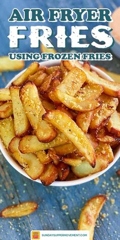 a white bowl filled with fried fries on top of a blue wooden table and text overlay reads air fryer fries using frozen fries