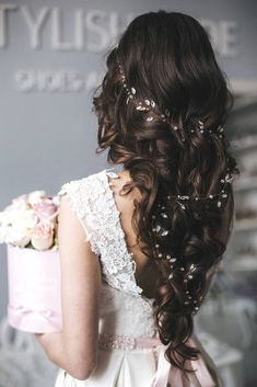 the back of a bride's head with flowers in her hair