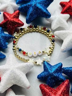 Show your patriotism with this festive USA bracelet. Perfect for Fourth of July, Memorial Day or any patriot loving event. Made with natural gemstones and 18k gold filled beads that are much more tarnish resistant and lasting opposed to the the more commonly seen gold plated. You will have this forever!  These bracelets layer well with others so add this to your stack! Sizing for girls and women. Beaded on high quality stretch cord and secured. - Choice of USA bracelet or set -  4mm 18k gold filled beads      4mm lapis stone (blue)    4mm quartz    4mm carnelian stone (red)    acrylic letters beads    mother of pearl stars     - If you would prefer different personalization other then "USA", please enter in personalization box - Each purchase is sent in a drawstring velvet jewelry bag, mak White Beaded Bracelets For 4th Of July Gift, Patriotic Red Beaded Bracelets As Gift, 4th Of July White Beaded Bracelets Gift, 4th Of July Gift Round Beads Stretch Bracelet, White Bracelets For Independence Day Gift, Independence Day White Bracelets Gift, White Bracelets For 4th Of July Gift, Patriotic Bracelets For 4th Of July Gift, White Patriotic Bracelet As Gift