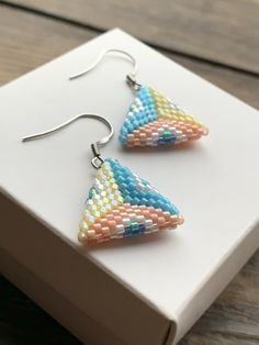 Hippie colorful beaded triangle dangle earrings would look great as a cute handmade jewelry for woman. Blue yellow peach cute jewelry can be a cool sister birthday gift. All my jewelry I sent in a minimalist white box. I also use additional packaging that will preserve and protect your purchase at the time of delivery. Thank you for visiting my shop. Hypoallergenic Beaded Earrings With Round Beads For Summer, Triangle Summer Earrings For Gift, Triangle Shaped Earrings For Summer Gift, Triangle Shaped Summer Earrings For Gift, Triangle Shaped Summer Earrings For Gifts, Summer Triangle Earrings For Gift, Adjustable Triangle Beaded Earrings, Adjustable Triangle Beaded Jewelry, Adjustable Triangular Beaded Jewelry