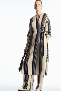 Crafted from a fluid blend of cupro and TENCEL™ Lyocell, this midi dress is detailed with contrasting panels that blend both wide and fine stripes for a modern look. Designed with a V-neckline and wide cuffs, it wraps over the body and is held in place by self-fabric ties.- Regular fit- Fabric-covered buttons, side slits- Cupro is a regenerated fibre made from cotton linter – the excess fibres that usually go to waste50% Cupro, 50% TENCEL™ Lyocell / Machine washBack length of size EU 36 is 120cm Midi Wrap Dress, Fabric Covered Button, Casual Street Style, Street Style Women, Striped Dress, Occasion Dresses, What To Wear, Casual Women, Wrap Dress