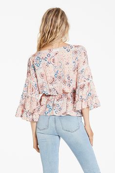 Lace eyelet top bell sleeve, with ruffle cuff opening, deep v-neck finished with elastic waistband. Multi print woven on relaxed fit, styled with decorative self covered buttons & loops.Body length from HPS: 23 1/2", Sleeve length: 18", Bust: 42" (Size Small) 100% RAYON Hand wash cold, Dry flat Imported Eyelet Top, Covered Buttons, Deep V Neck, Bell Sleeve, Fig, Bell Sleeve Top, Hand Wash, Relaxed Fit, Cuff