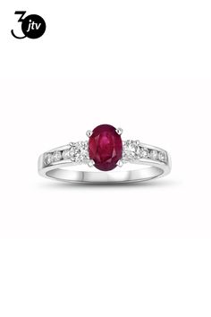 a white gold ring with an oval ruby stone and two diamonds on the side, set in