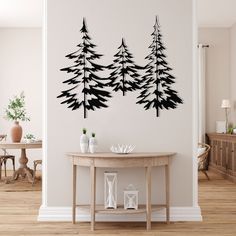 a living room with a table and some trees on the wall