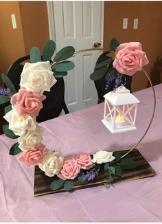 a pink and white flower arrangement on a table