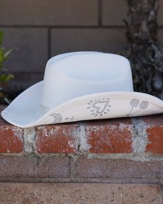 Celebrate in style with our Ivory Rhinestone Studded Disco Cowgirl Hat! This extra cute white cowgirl hat features rhinestone embellishments under the brim. From cherries to hearts, boots and crescent moons, this blingy cowgirl hat may cause compliments at your next concert. Pair with your favorite corset top, shorts and boots for a groovy night out! White Flat Brim Hat For Ranch, White Country Style Hat With Flat Brim, Western White Hat With Curved Brim, White Western Hat With Short Brim, White Wide Brim Western Hat, White Western Hat With Flat Brim, White Western Hat For Spring, White Hats For Western-themed Events, White Western Hat For Western-themed Events