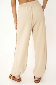 FINAL SALE - NO RETURNS. Feel free to email us at hello@shopmaude.com regarding sizing, fit, or our return policy. We just made the perfect pant. We'll take a bow.The Take A Bow Tie Bottom Parachute Pant is one you'll always find an excuse to wear. This pant features an elasticized high waistband, side pockets, raw edge details throughout, and tie ankle details to create the perfect parachute silhouette. 70% Cotton30% Rayon Care Instructions: Machine wash cold.Wash inside out with similar colors Chic Wide Leg Pants With Ribbed Waistband For Fall, Wide Leg Pants For Elevated Casual Wear, Elevated Casual Bottoms With Elastic Waistband For Fall, Elevated Casual Fall Bottoms With Elastic Waistband, Elevated Casual Elastic Waistband Bottoms For Fall, Fall Sweatpants For Elevated Casual Wear, Solid Color Wide-leg Bottoms For Elevated Casual, Fall High-waisted Wide Leg Pants For Elevated Casual, Solid Wide-leg Bottoms For Elevated Casual Wear