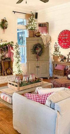 a living room filled with furniture and christmas decorations