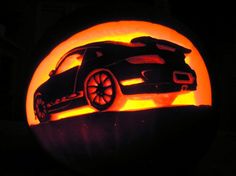 a car carved into the side of a pumpkin