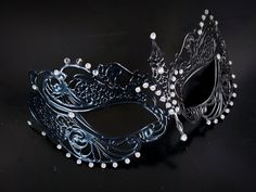 This captivating set includes two stunning masks, both designed in the classic Venetian style. The mask is adorned with sparkling rhinestones, reflecting the light and adding a touch of enchantment to her look while the black mask includes shimmer and exudes strength and sophistication, making him a charismatic presence at any masquerade or other special events.


Age Group/Gender - Adult/Unisex

Size/Type - One size fits all adults

Mask Color - Black
Mask Material - Metal women's, polyresin me Elegant Evening Eye Mask, Gothic Evening Masquerade Eye Mask, Gothic Eye Mask For Evening Masquerade, Elegant Party Eye Mask, Elegant Eye Mask For Party, Elegant Masquerade Eye Mask, Elegant Evening Mask For Carnival, Elegant Evening Masks For Carnival, Elegant Party Masks And Prosthetics