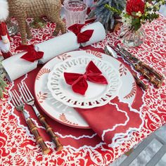 a red and white table setting with place settings