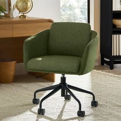 a green office chair sitting on top of a white rug in front of a desk