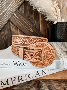 A full tooled leather belt with matching leather buckle. A statement to any outfit. 100% Leather Belt Width: 1.5" Small 32" | 30"-34" Medium 36" | 34" - 38" Large 40" | 38" - 42" **All measurements are taken from top of the belt to the first and then to the last hole** Buckle can be removed Tooled Belt, Cowgirl Couture, Tooled Leather Belts, Tan Leather Belt, Leather Belt Buckle, Western Accessories, Cowgirl Jewelry, Tool Belt, Wedding Belts