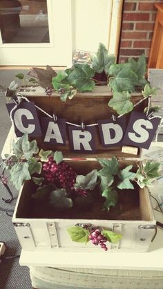 an old trunk is filled with grapes and cards