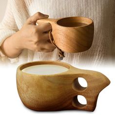 a person holding a wooden cup with holes in it and the lid opened to reveal a liquid inside